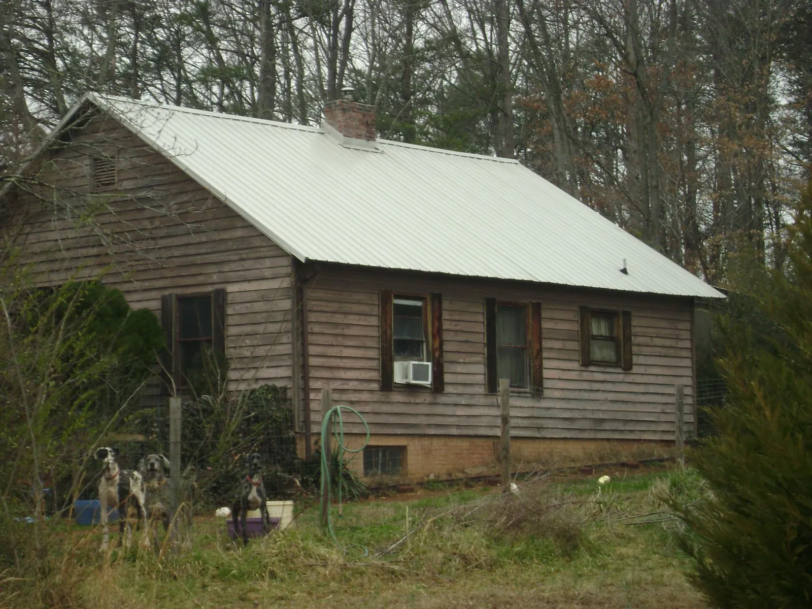 White metal roof on an old wood sided farmhouse, from a Metal Roof Installation job in Youngwood